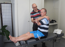Our Strathpine chiropractor Dr David Malone performing a chiropractic adjustment