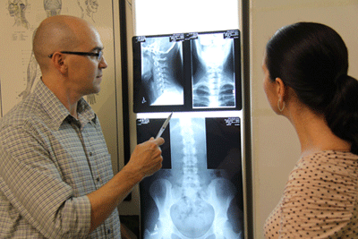 Chiropractor Dr Malone explaining findings to client